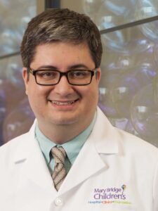 Headshot of Dr. Escobar wearing his Mary Bridge Children's white coat