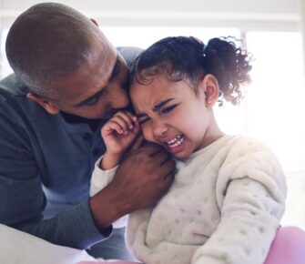 Dad consoles crying daughter