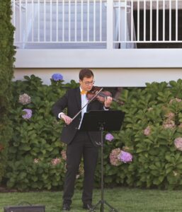 Young man in a tuxedo playing violin