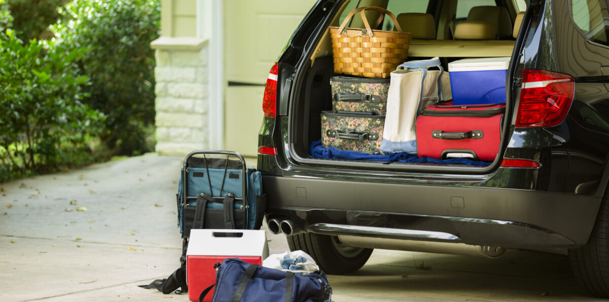 Family vehicle packed, ready for road trip, vacation outside home.