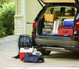 Family vehicle packed, ready for road trip, vacation outside home.