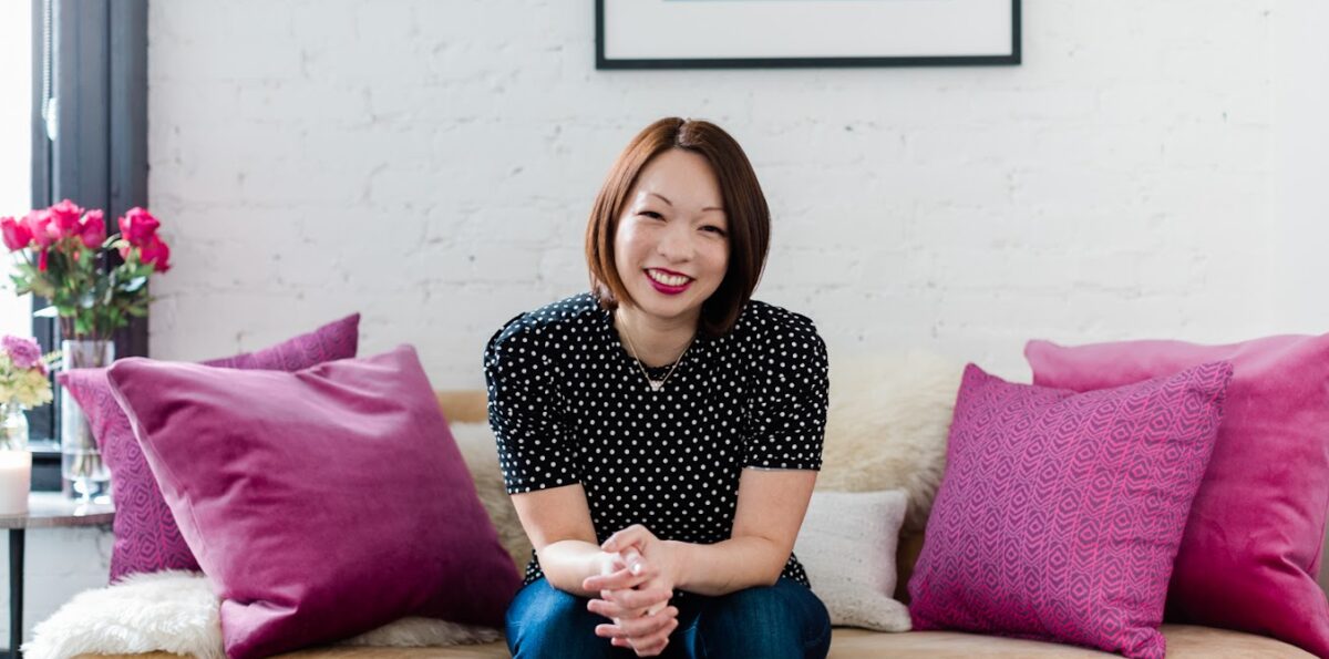 Tamara Chang, MD, sits on a couch.