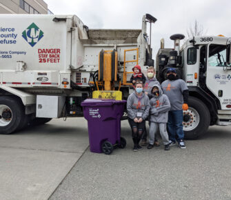 Easton and family pose with a garbage truck during a parade of garbage trucks at Mary Bridge Children’s.