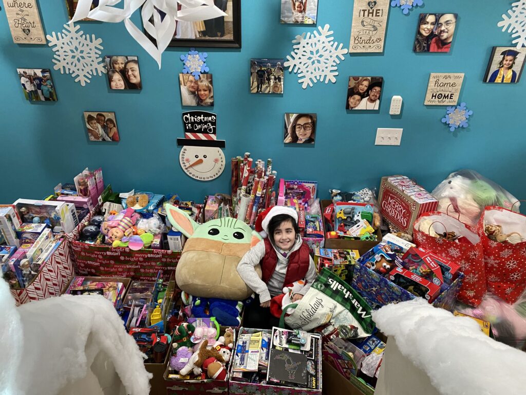 Evangeline surrounded by all of the toys she collected for Mary Bridge Children’s.