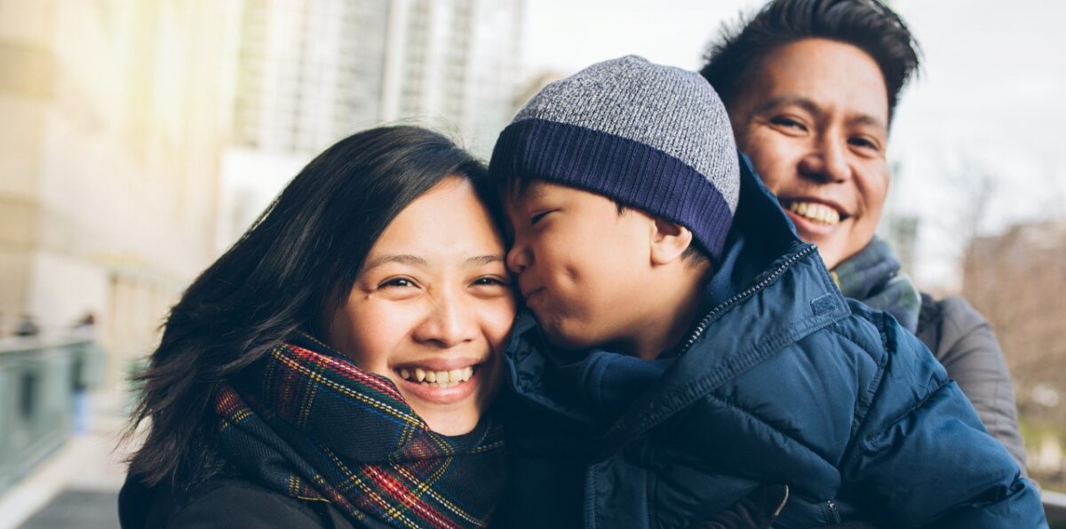 Bundled up family walks outside.