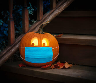 Lighted Halloween Pumpkin Jack o Lantern Wearing Covid PPE Mask On Steps