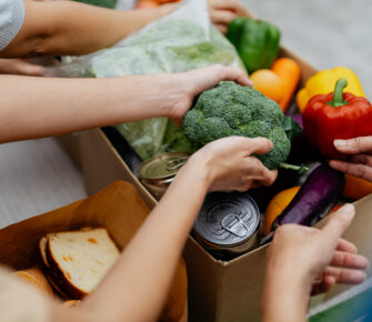 Volunteers packing donated goods and groceries at food bank