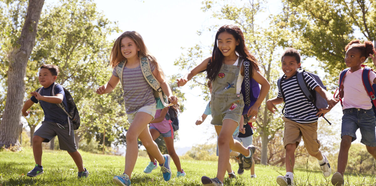 Group of schoolchildren running in the park