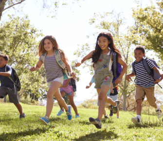 Group of schoolchildren running in the park