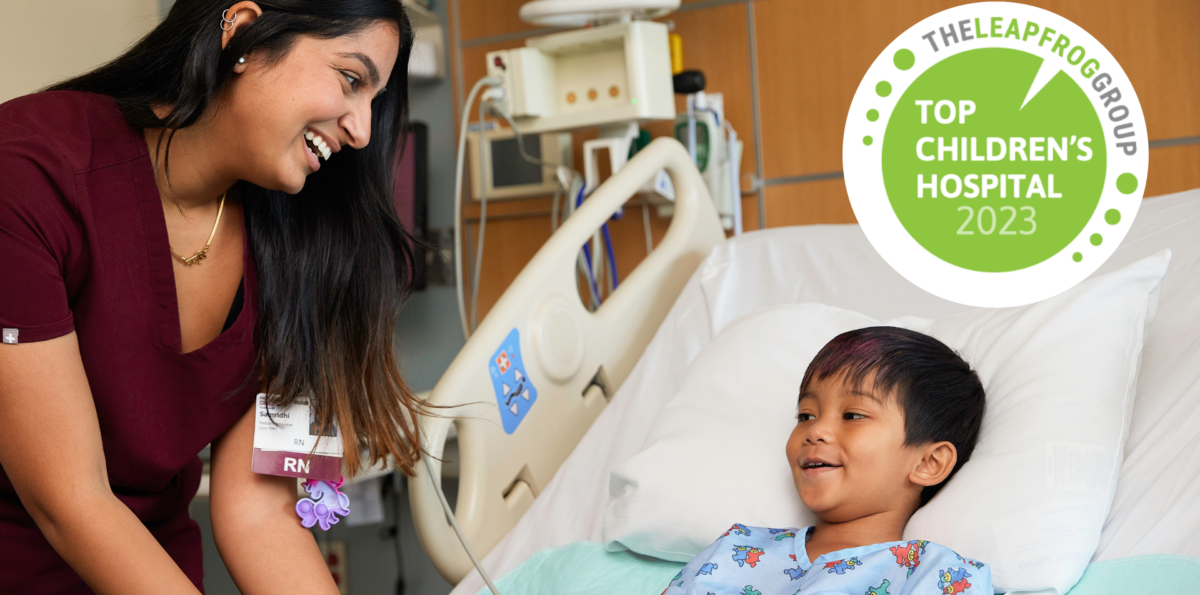 Nurse smiles at little boy in hospital bed. Leap Frog Best Hospital badge 2023 overlays.