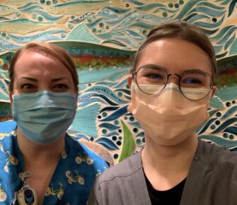 Nicole Geffrey, RN, and Emily posing for a picture together at Mary Bridge Children's Hospital.