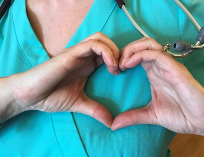 Nurse makes a heart with her hands