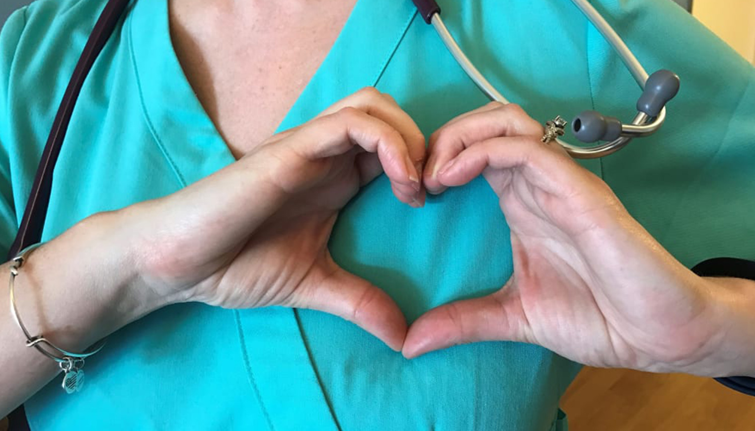 Nurse makes a heart with her hands