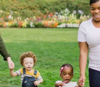 Two moms with their children in a park.