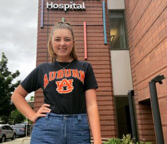 Payton Allen stands in front of Mary Bridge Children's Hospital in Tacoma, Washington.