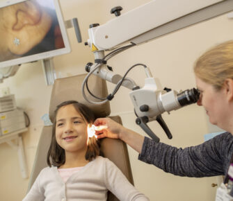 Young girl having her ear examined in a medical clinic.