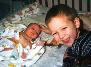 Emily as an infant in the hospital with her brother Tyler by her side.