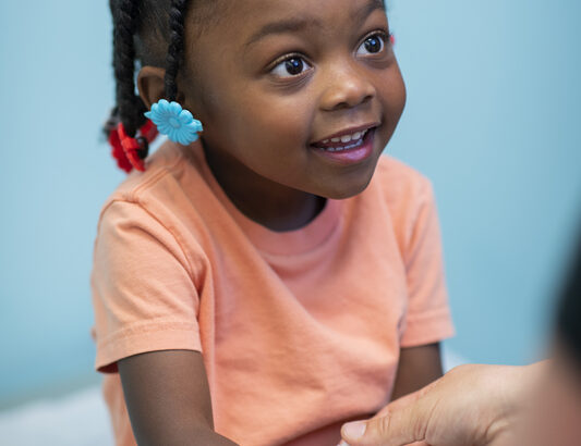 Young girl has her arm bandaged.